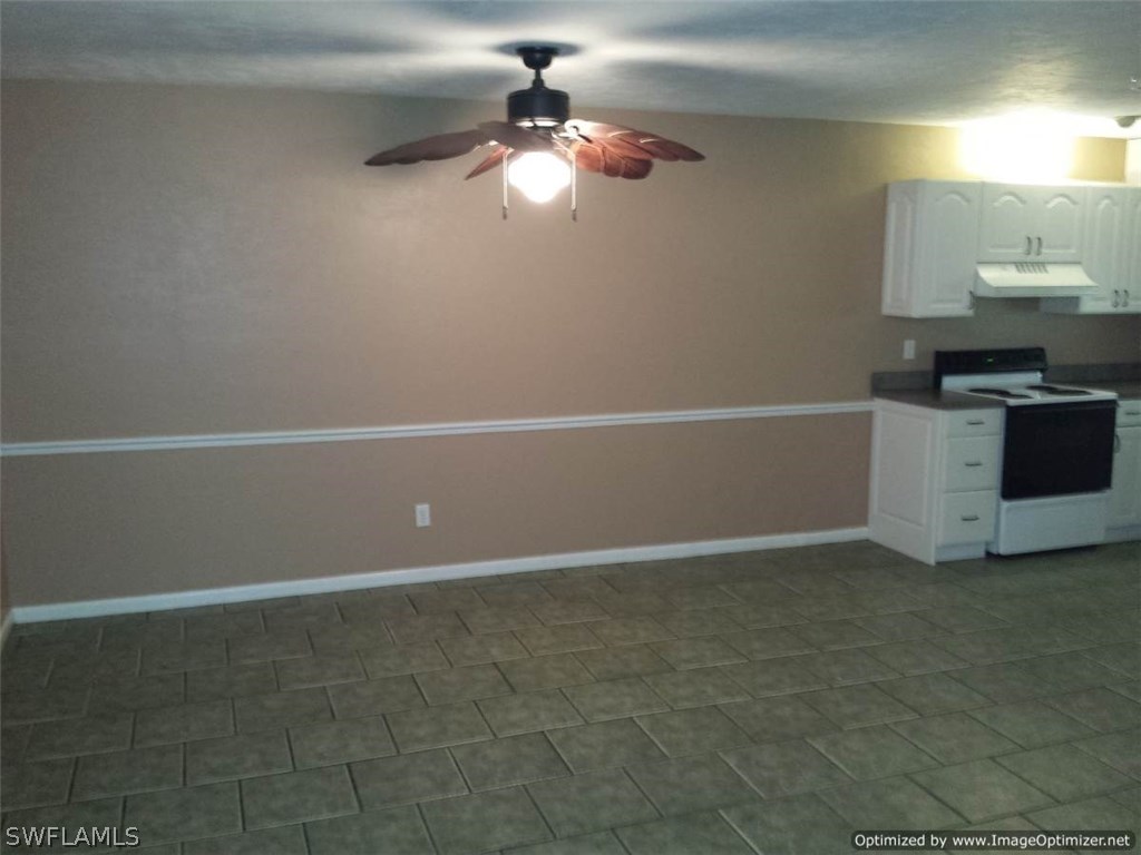 7263 Barragan Road, Unit 3 Fort Myers, FL 33967 - Photo 6 of 11 a view of an empty room with a chandelier fan
