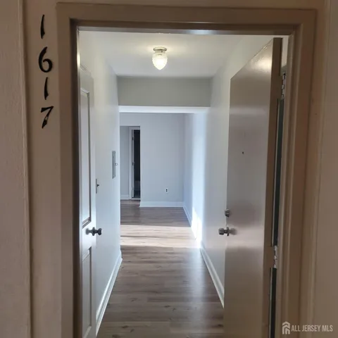 a view of a hallway with wooden floor