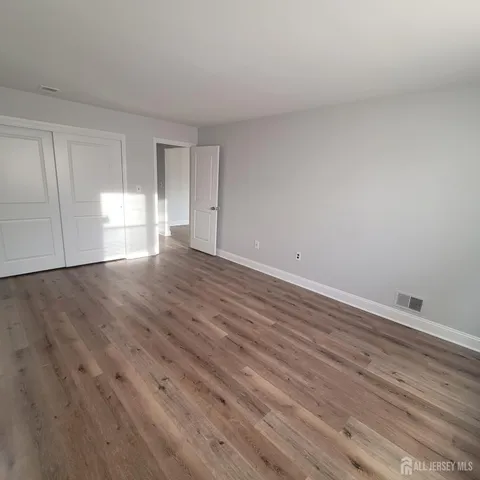 a view of wooden floor and windows in a room