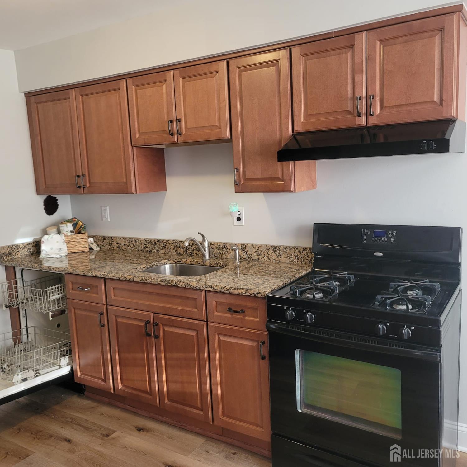 1617 Raspberry Court Edison, NJ 08817 - Photo 3 of 15 a kitchen with granite countertop a stove a microwave cabinets and a sink