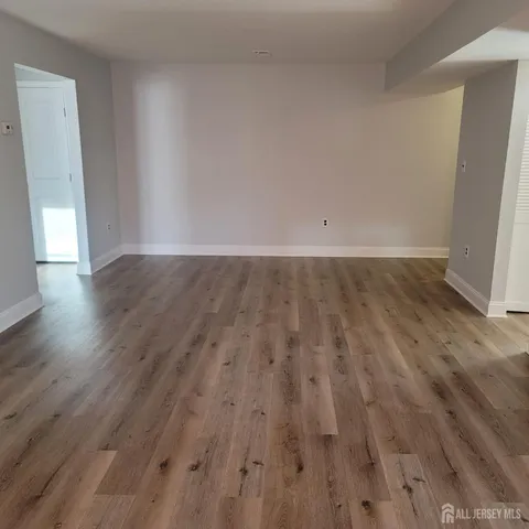 an empty room with wooden floor