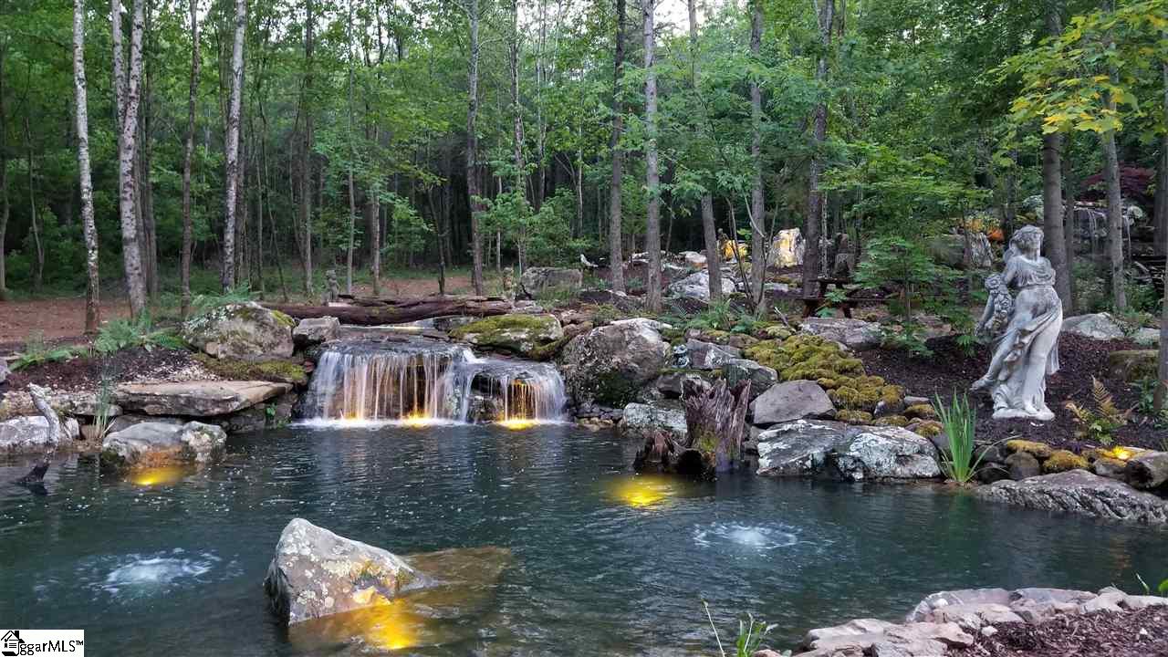 160 Forestville Road Travelers Rest, SC 29690 - Photo 3 of 36 The ideal future homesite would be just behind this pond and to the left of the stream. The possibilities are really endless!