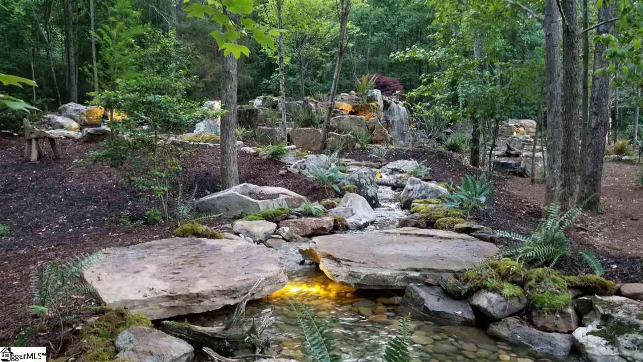 160 Forestville Road Travelers Rest, SC 29690 - Photo 7 of 36 Two 4,000+ lb boulders were used to create a bridge to get from the future home site to the picnic/entertaining area.
