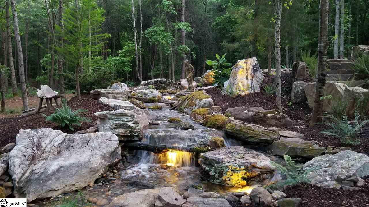 160 Forestville Road Travelers Rest, SC 29690 - Photo 8 of 36 Designed to mimic a mountain stream. Boulders have been carved in and sunken into the ground to give the appearance the water has eroded away the soil and exposed the stone.