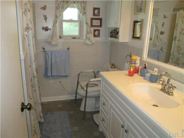 338 Guy Road Angier, NC 27501 - Photo 13 of 13 a bathroom with a sink vanity granite tub and shower