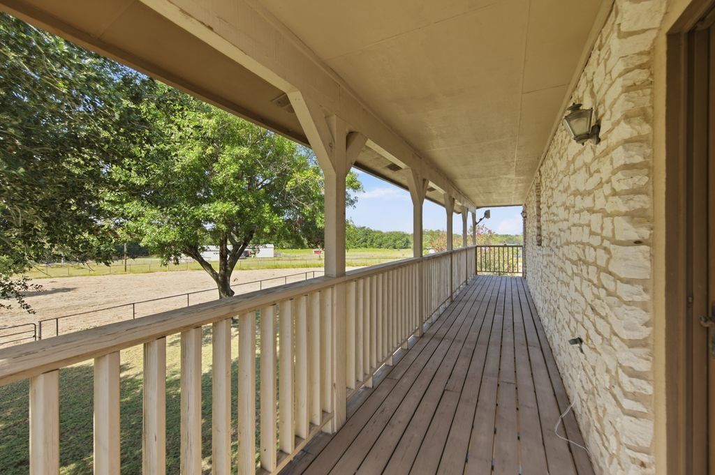 1454 Red Town Road Elgin, TX 78621 - Photo 18 of 40 A spacious covered porch offers tranquil views of the verdant yard and distant landscape.