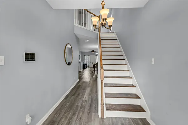 a view of entryway and hall with wooden floor