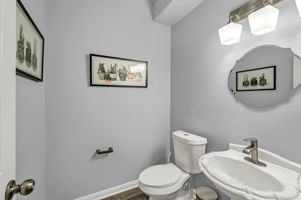 a white toilet sitting next to a bathroom sink