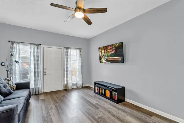 a view of room with window and wooden floor