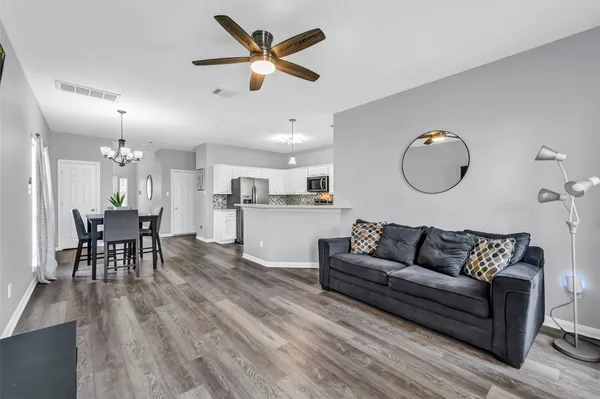 a living room with furniture and kitchen view