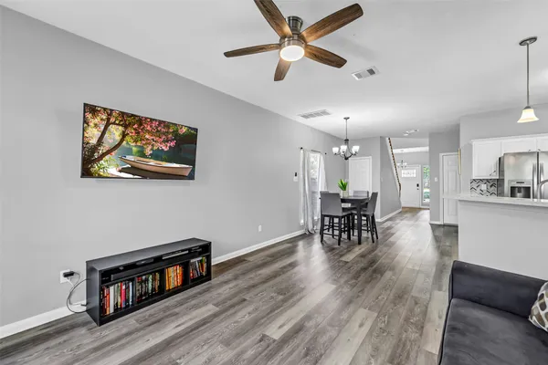 a living room with furniture and a wooden floor