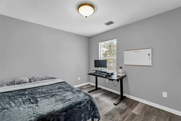 a bedroom that has a bed and a table in it