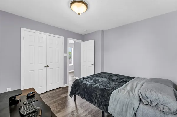 a bedroom with a bed and a dresser