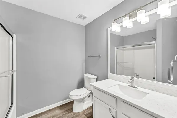 a bathroom with a sink vanity and toilet