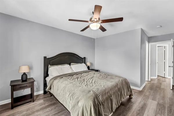 a bedroom with a bed and wooden floor