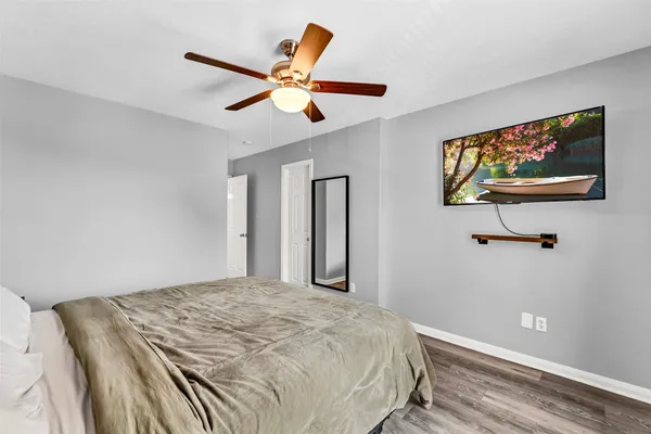 a bedroom with a large bed and a chandelier