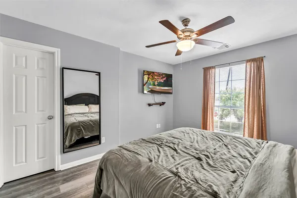a bedroom with a large bed and a large mirror