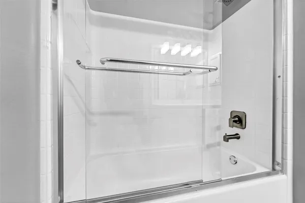 a bathroom with a bathtub and a shower