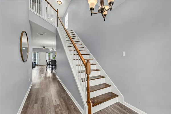 a view of entryway and hall with wooden floor