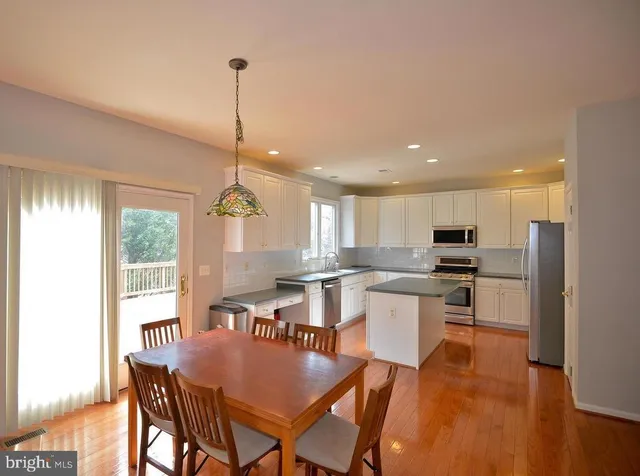 a large kitchen with a table and chairs