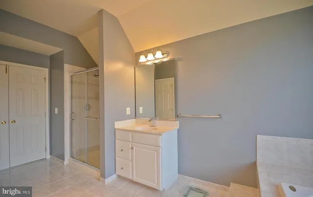 a view of a bedroom with furniture and window