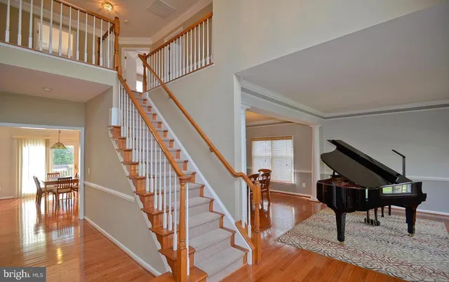 a view of entryway and hall with wooden floor