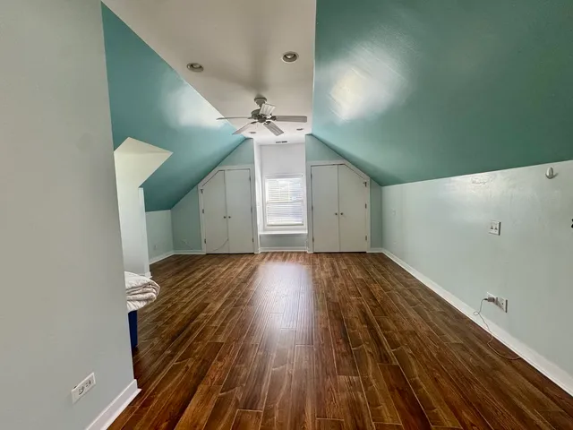 a view of a room with wooden floor and staircase