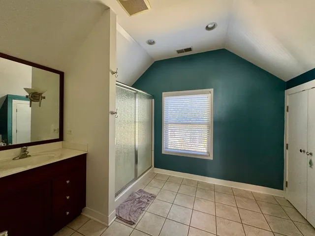 a view of an empty room with window and cabinet