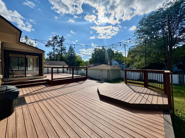 a balcony with wooden floor and fence