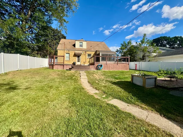 a view of a swimming pool with an outdoor seating and a yard