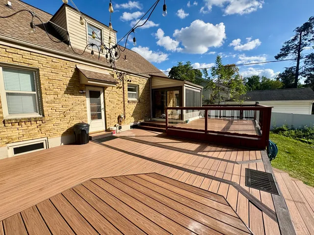 a view of balcony with wooden floor and fence