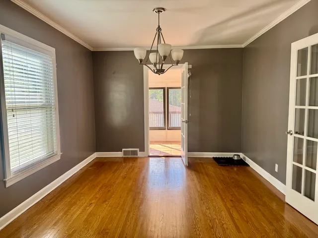 a view of a room with wooden floor and windows
