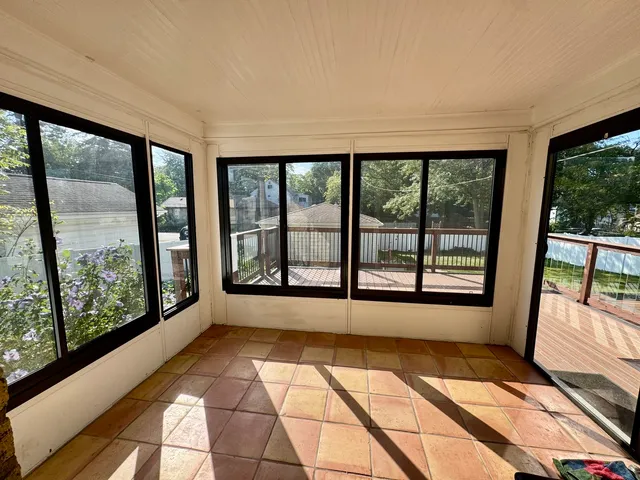 a view of empty room with large windows