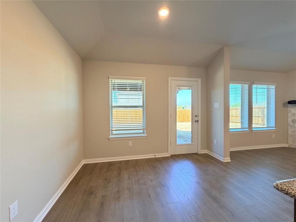 5401 Inwood Drive Denton, TX 76207 - Photo 11 of 21 an empty room with wooden floor and windows