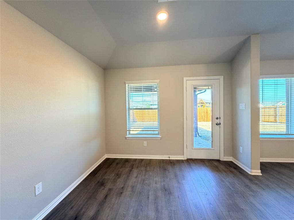 5401 Inwood Drive Denton, TX 76207 - Photo 12 of 21 an empty room with wooden floor and windows