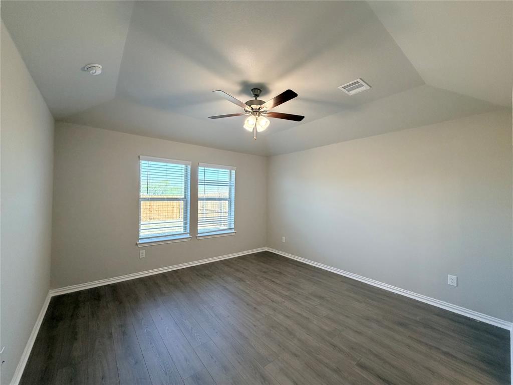 5401 Inwood Drive Denton, TX 76207 - Photo 13 of 21 an empty room with wooden floor and windows