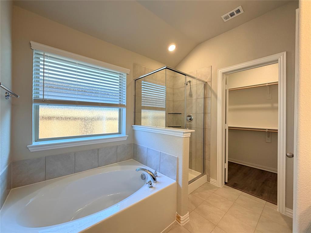 5401 Inwood Drive Denton, TX 76207 - Photo 14 of 21 a bathroom with a bathtub and a shower