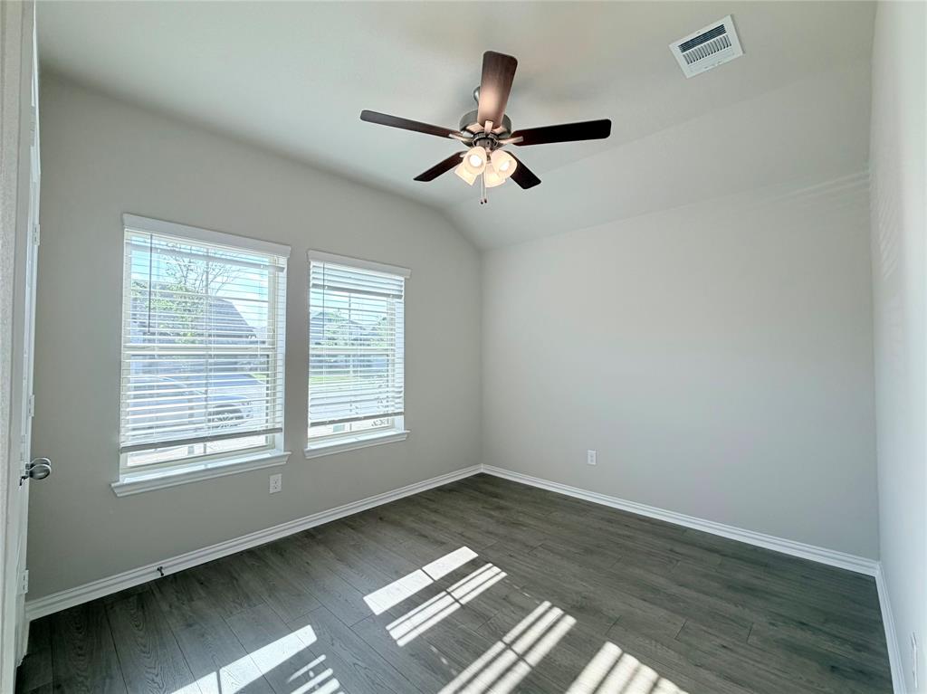 5401 Inwood Drive Denton, TX 76207 - Photo 16 of 21 a view of empty room with wooden floor and fan
