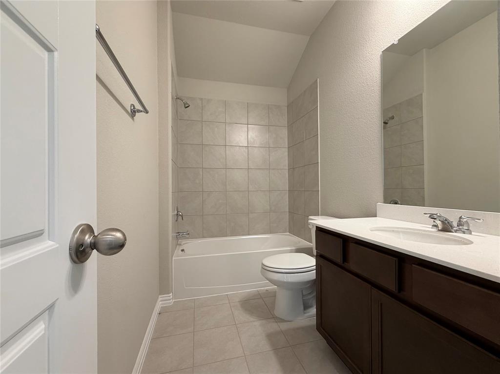 5401 Inwood Drive Denton, TX 76207 - Photo 17 of 21 a bathroom with a sink a toilet and shower