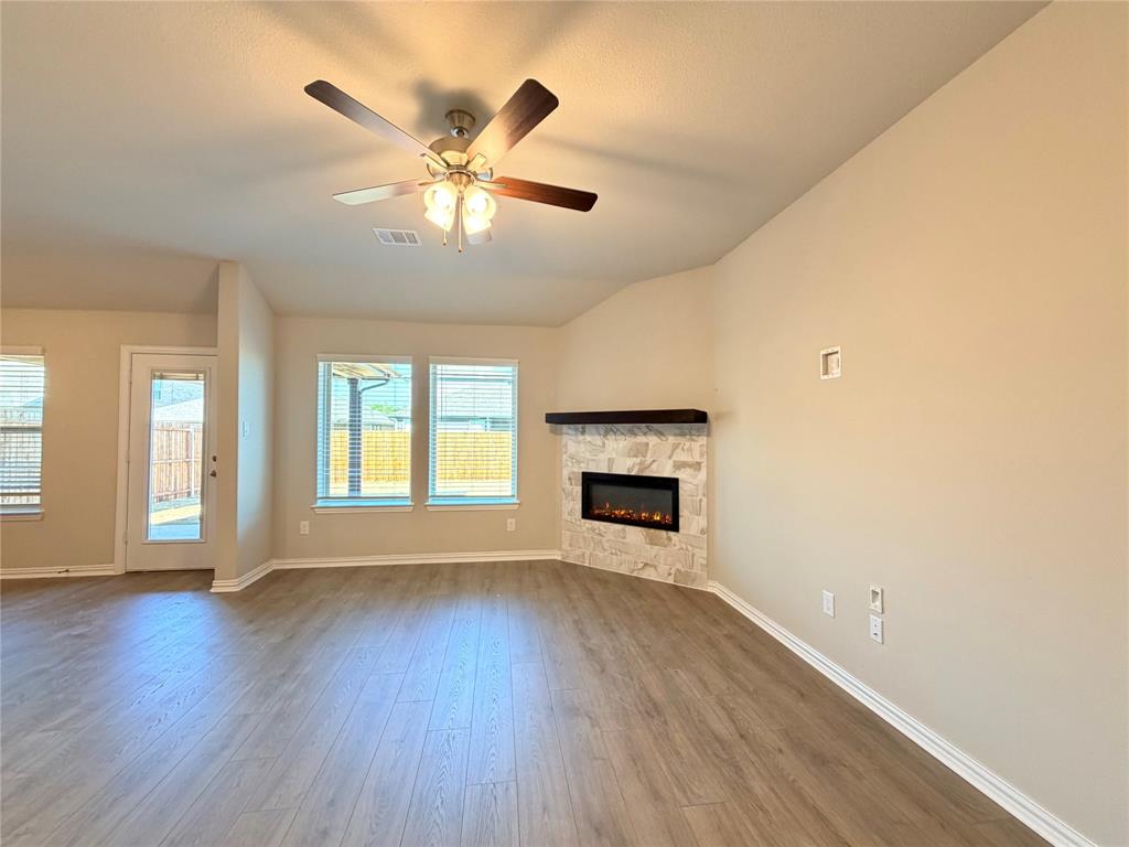 5401 Inwood Drive Denton, TX 76207 - Photo 5 of 21 a view of an empty room with wooden floor and a window