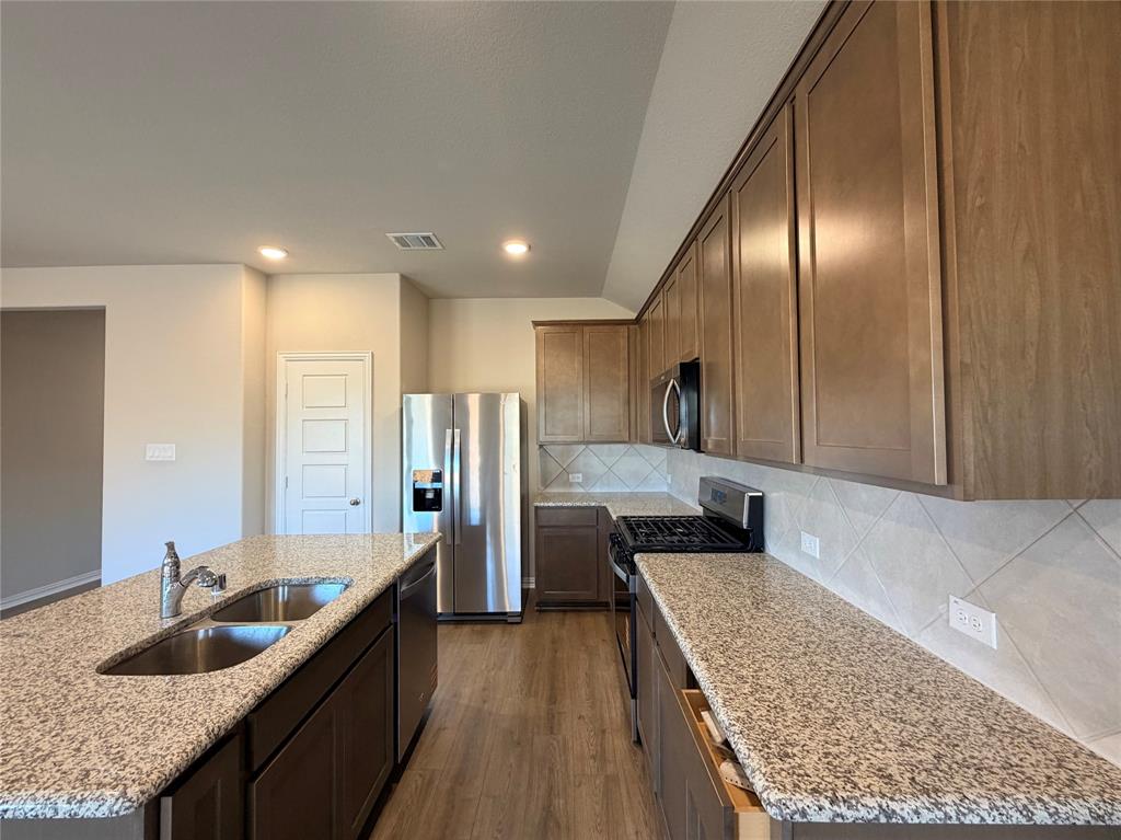 5401 Inwood Drive Denton, TX 76207 - Photo 7 of 21 a kitchen with stainless steel appliances granite countertop a sink stove and refrigerator
