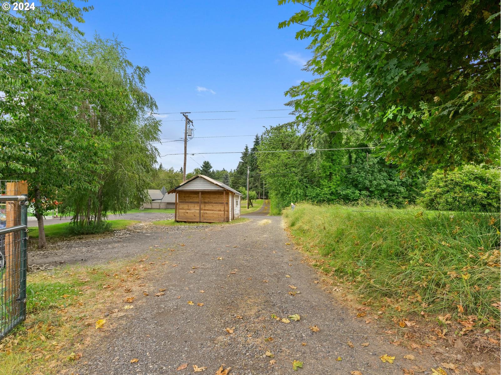 16091 Southeast Royer Road Damascus, OR 97089 - Photo 32 of 41 a view of a dirt road with a building in the background