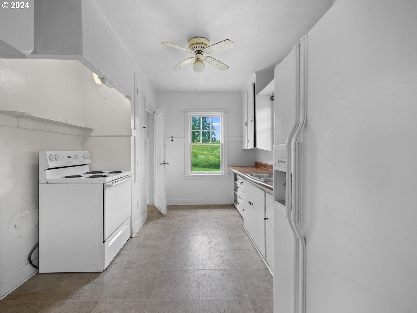 16091 Southeast Royer Road Damascus, OR 97089 - Photo 9 of 41 a kitchen with white cabinets and white appliances