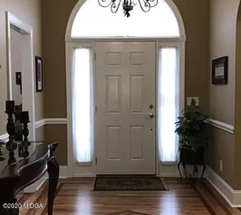 9743 Lower Thomaston Road Macon, GA 31220 - Photo 2 of 28 an empty room with wooden floor and windows