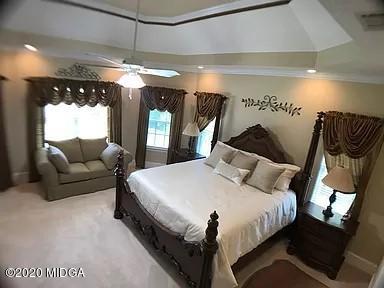 9743 Lower Thomaston Road Macon, GA 31220 - Photo 14 of 28 a bed room with a bed and a large mirror