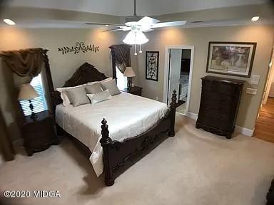 9743 Lower Thomaston Road Macon, GA 31220 - Photo 15 of 28 a bed room with a bed and a chandelier