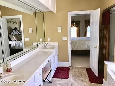9743 Lower Thomaston Road Macon, GA 31220 - Photo 16 of 28 a en suite bathroom with a sink and a mirror