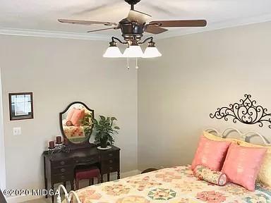 9743 Lower Thomaston Road Macon, GA 31220 - Photo 18 of 28 a bedroom with a bed and a chandelier