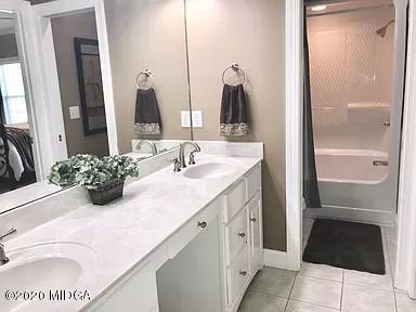 9743 Lower Thomaston Road Macon, GA 31220 - Photo 19 of 28 a bathroom with a double vanity sink and a mirror