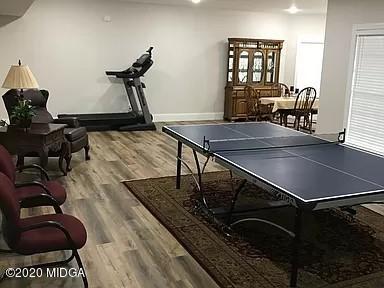9743 Lower Thomaston Road Macon, GA 31220 - Photo 24 of 28 a room with gym equipment and wooden floor